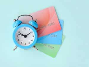 Alarm Clock in front of credit cards